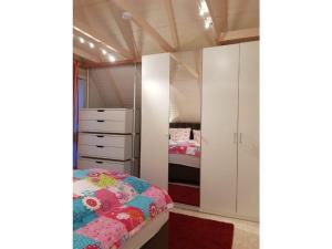 a bedroom with a bed and a bedroom with two beds at 1-bedroom holiday home in Otterndorf