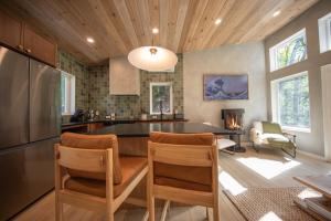 a kitchen with a table and chairs in a room at Cozy Luxury Cabin w Hot Tub, Fire Pit, King Bed in Newry