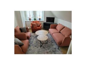 a living room with two couches and a table at One-bedroom apartment in Borkum