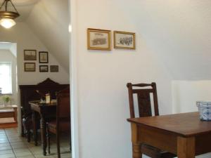 a dining room with a table and a piano at One-bedroom apartment in Borkum +10 photos