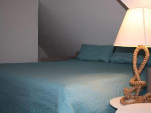 a bedroom with a bed with a lamp on it at Holiday apartment in Baabe with swimming pool in Baabe