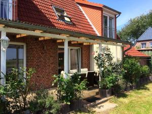 a brick house with a red roof at Holiday home with 3 bedrooms in Neukrug