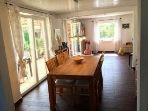 a dining room with a wooden table and chairs at Holiday home with 3 bedrooms in Neukrug