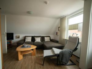 a living room with a couch and a table at -CANCER- in the -muschelsöker- in Langeoog