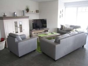 a living room with two couches and a tv at Holiday home with 4 bedrooms in Wittendün