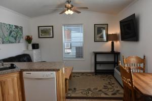 a kitchen with a table and a ceiling fan at Cozy Home by Yellowstone River Confluence in Gardiner