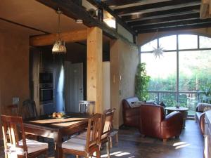 a living room with a wooden table and chairs at Holiday home with 3 bedrooms in Tewswoos