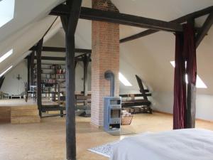 a bedroom with a fireplace in a loft at Holiday home with 3 bedrooms in Tewswoos