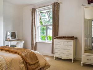 a bedroom with a bed and a window and a dresser at Cooperative Cottage - Uk44502 in Saddleworth +5 photos