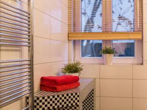two red towels sitting on a table in a bathroom at Family accommodation in Dresden +14 photos