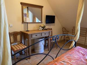 a bedroom with a bed and a desk with a mirror at Wellness Residence Apartment 12 in Zingst