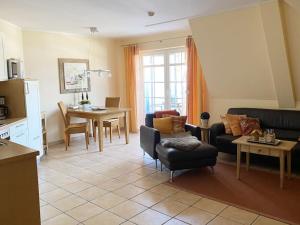 a living room with a couch and a table at Wellness Residence Apartment 12 in Zingst