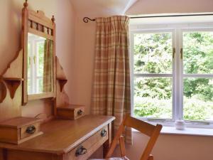ein Frisiertisch und ein Fenster in einem Zimmer in der Unterkunft Wood Cottage in Cheriton + 10 Fotos