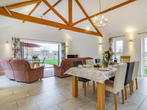a dining room with a table and chairs at Barrow Barn in Wicken