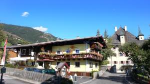 a building with flowers on the balconies of it at Hotel Dorfgasthof Schlösslstube in Stuhlfelden