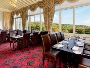 a dining room with tables and chairs and large windows at Family Lodge No 2 The Place Upstairs - Uk45687 in Moulin