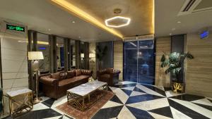 a lobby with couches and a table in a building at Taj Hotel Premium Residency F-7 Islamabad in Islamabad