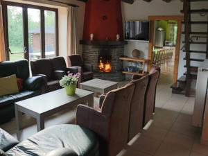 a living room with a couch and a fireplace at Elegant Bevercé Escape in Malmedy