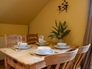 a wooden table with plates and wine glasses on it at Mange-Tout Maison - Uk32607 in Manton