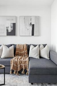 a living room with a couch with a blanket on it at Stylish 1BR Condo in the heart of the Downtown TO in Toronto