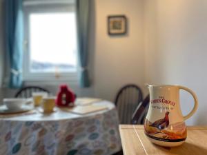 a coffee cup sitting on top of a table at The Old Surgery in Kinlochbervie