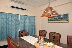 a dining room with a table and chairs at Experience the grandeur of City of Joy at Anutham in Kolkata