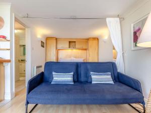 a blue couch in a room with a bed at Studio Sea Urchin in Carbis Bay +11 photos