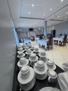 a group of bowls and plates on a table at HOTEL arruda MARITUBA in Marituba +17 photos