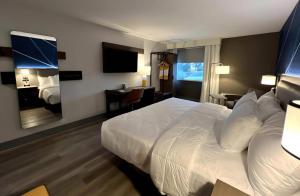 a hotel room with a white bed and a desk at Comfort Inn in Princeton