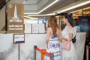 two women standing in a store looking at a window at The Landmark Luxury - Apartment in Ho Chi Minh City +111 photos