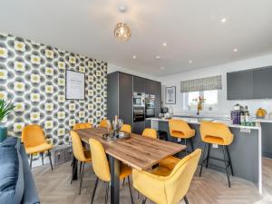 a kitchen and dining room with a wooden table and chairs at Sandbanks in Bridlington