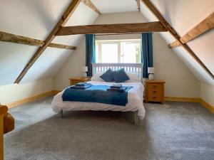 a bedroom with a bed and a window at The Dairy - Uk48866 in Aylsham