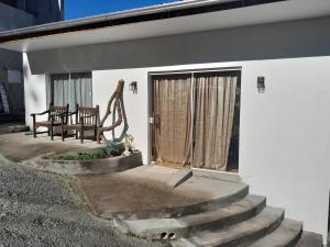 a patio with stairs leading to a white house at Pousada Baden Baden in Blumenau