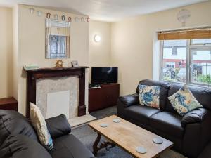 a living room with a couch and a fireplace at Happy Days in Whitby