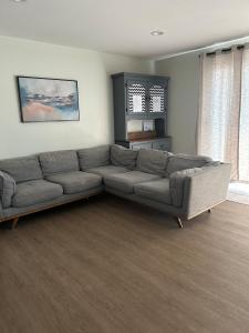 a living room with a gray couch in a room at Cozy Corner in Federal Way in Federal Way