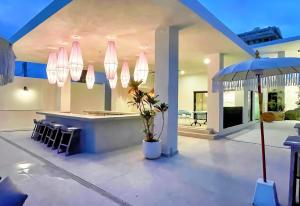 a house with a bar with chairs and an umbrella at Bali Hotel Adults Only Isla Verde, a Trademark by Wyndham in Carolina +137 photos