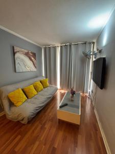 a living room with a couch and a table at Catedral Centro in Santiago