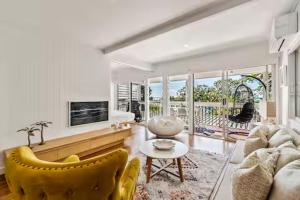 a living room with a couch and a table at Seaviews Little Cove Beach Noosa 2BR 200m to beach in Noosa Heads