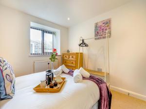 a bedroom with a bed with a tray on it at Harebell- Uk45262 in Whitby +7 photos