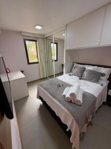 a bedroom with a large bed with towels on it at Life Resort, Trabalho e Lazer! in Brasilia