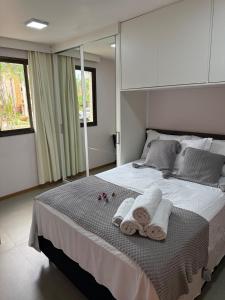 a bedroom with a large bed with towels on it at Life Resort, Trabalho e Lazer! in Brasilia +52 photos