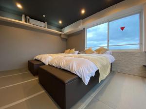 a bedroom with a large bed and a window at Empire Skyridge Hotel - Vacation STAY 17783 in Chikugo