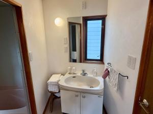 a bathroom with a sink and a mirror at PinKumano by WhyKumano in Nachikatsuura +12 photos