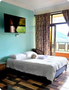 a bedroom with a bed and a large window at Finca Hotel Tara in Barbosa +89 photos