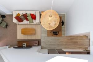 a kitchen with a table and a fan on the wall at Central Christchurch Apartment with Parking in Christchurch