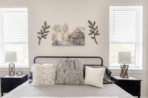 a bedroom with a bed with two pictures on the wall at 3b/3b River Townhome A for 6, Steps Gruene Hall in Gruene
