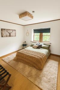 a bedroom with a large bed and a window at Locanda Madarao Tangram with Complimentary 8 Seater Van in Shinano
