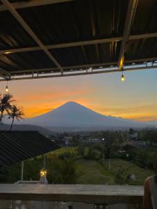 a view of a mountain at sunset at AMED LILI Hostel & Private Room in Amed