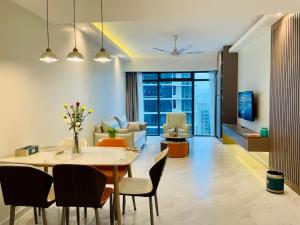 a dining room and living room with a table and chairs at Eaton Suites KLCC Kuala Lumpur in Kuala Lumpur +86 photos