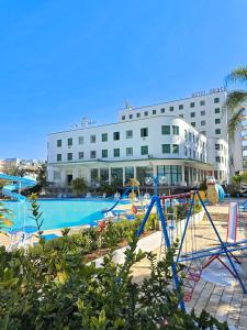 a hotel with a playground in front of a building at Hotel Brasil in São Lourenço